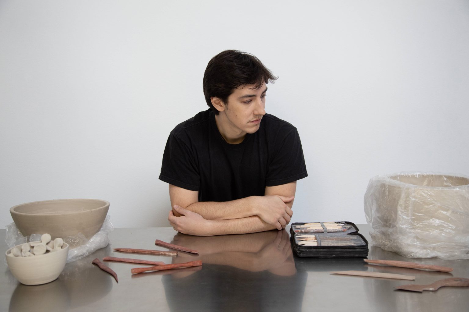 Daniel Pontoriero in the DAPOTTERY studio surrounded by clay forms