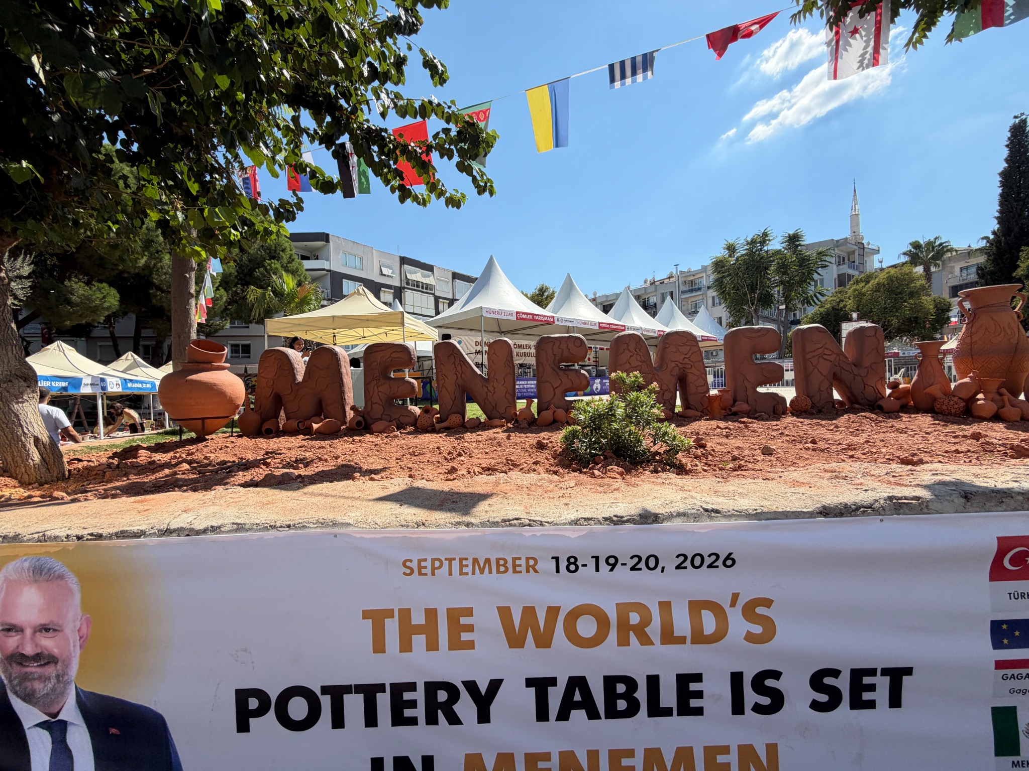Menemen festival installation beneath international flags